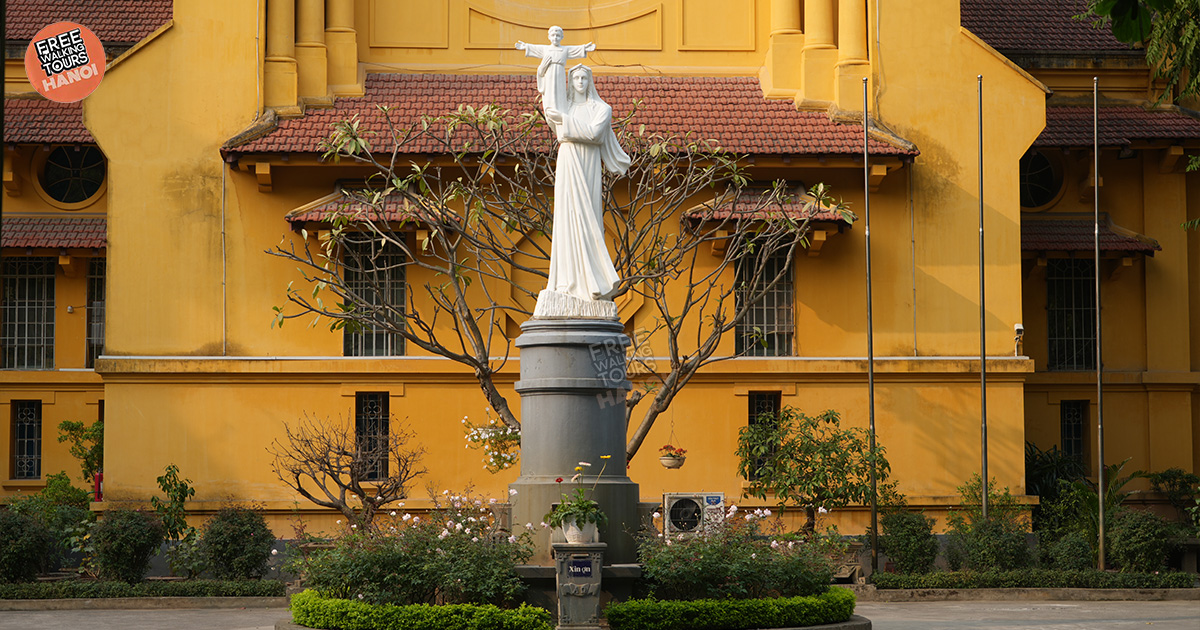 Natural light filters through the church’s high windows, revealing the wooden textures that mirror Vietnamese architectural traditions.